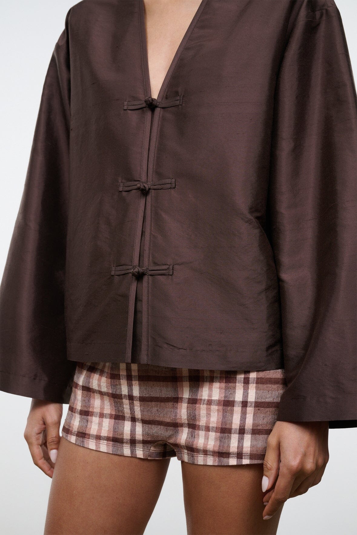 Dark brown silk dupioni top close-up: V-neck with three fabric toggle closures