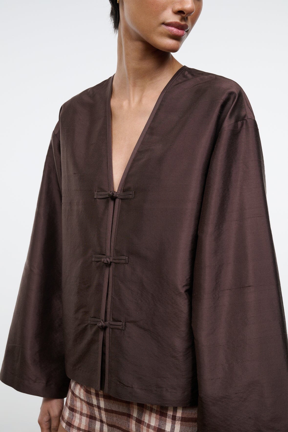 Dark brown silk dupioni top close-up with V-neck and three toggle button closures