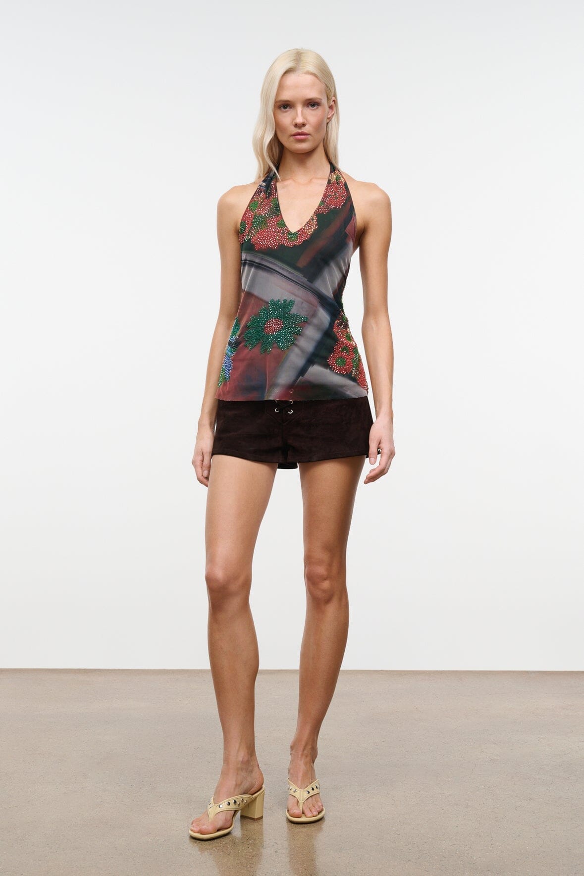 Sleeveless beaded V-neck top with dark floral motifs, sheer fabric and multicolor beads