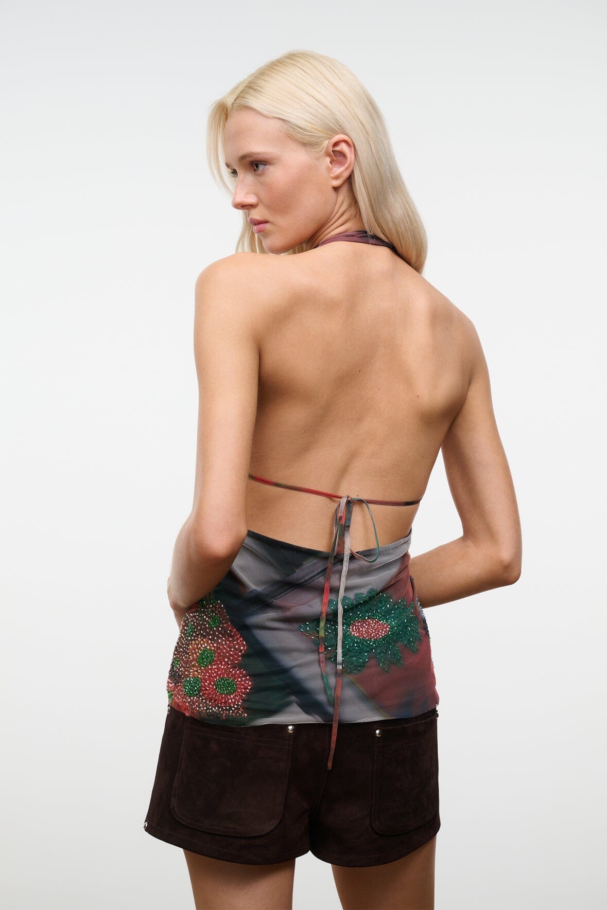 Backless sleeveless beaded top with tie-back strings, dark floral pattern on sheer fabric