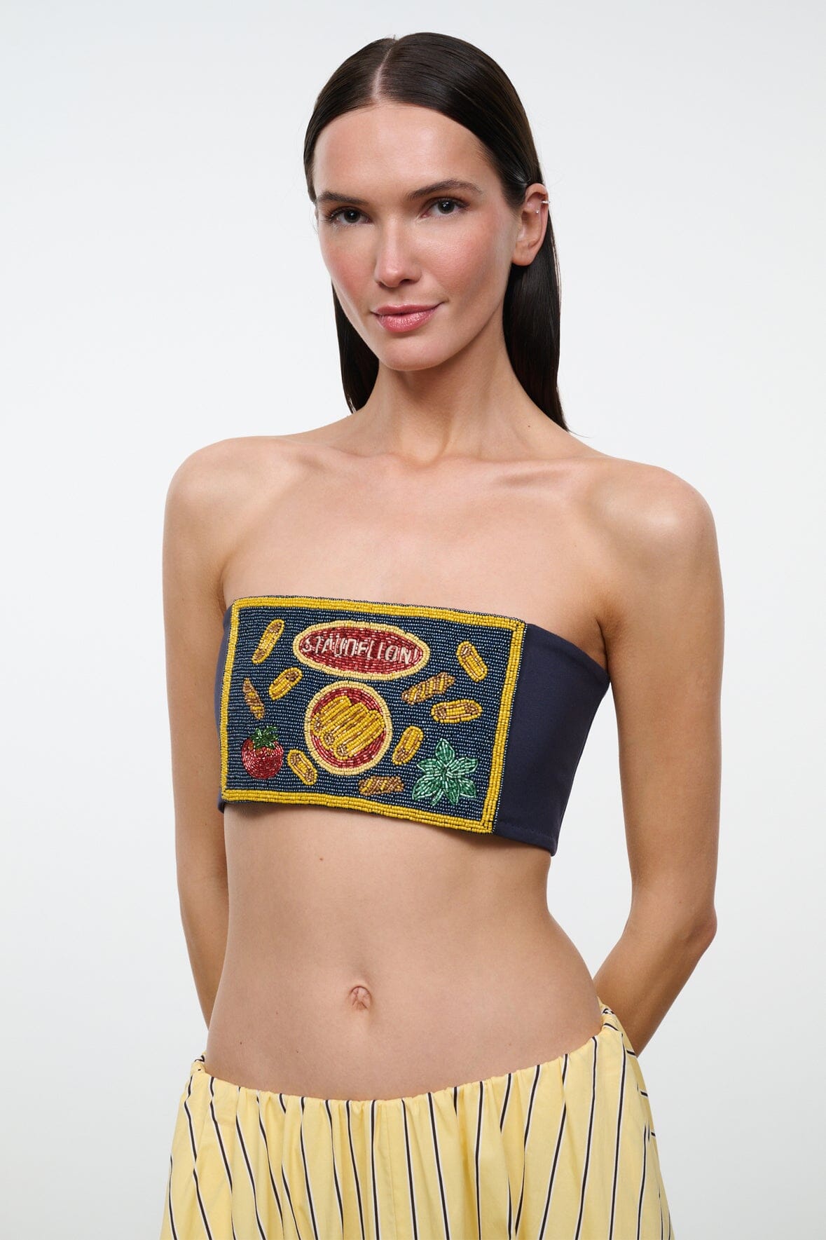 Strapless navy tube top with embroidered graphic patch and yellow edge