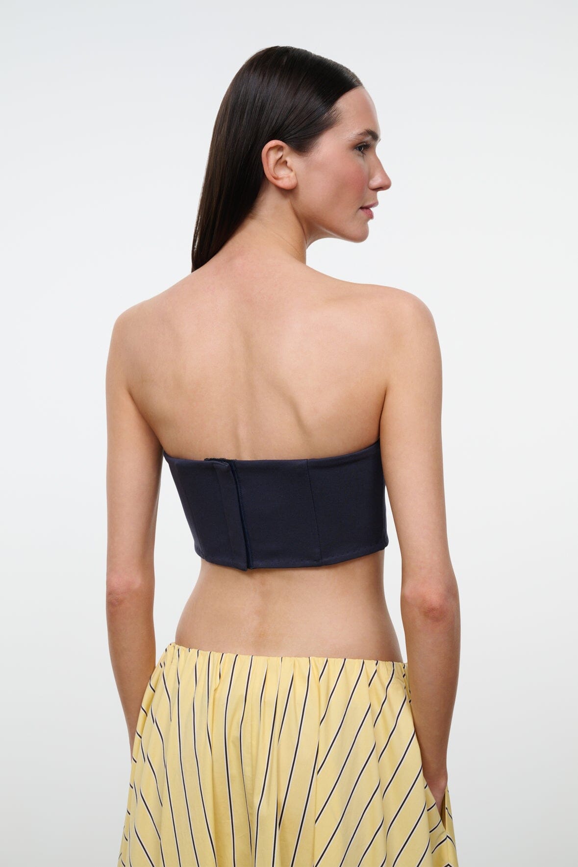 Back view of navy strapless tube top with smooth fitted bodice
