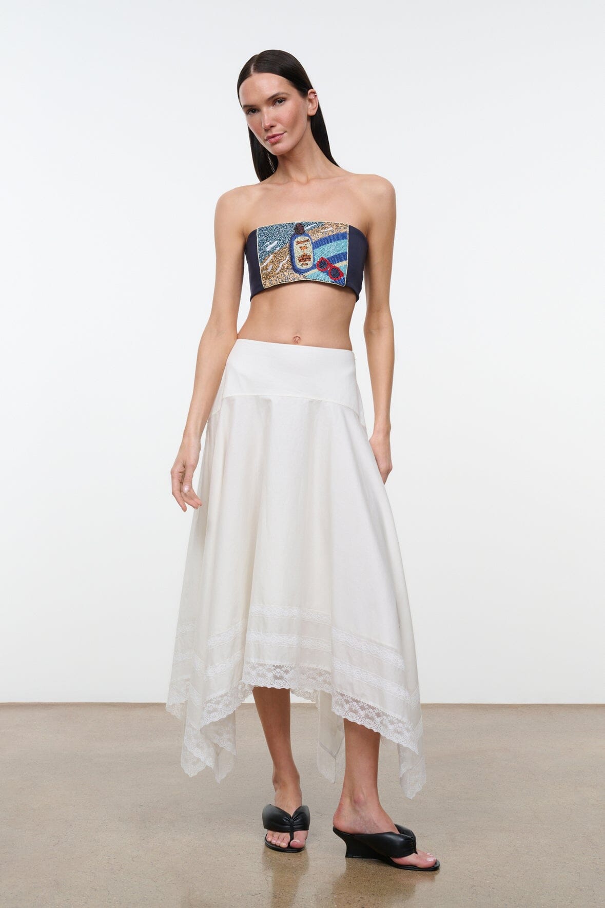 Front view strapless tube top with navy band and multicolor graphic patch