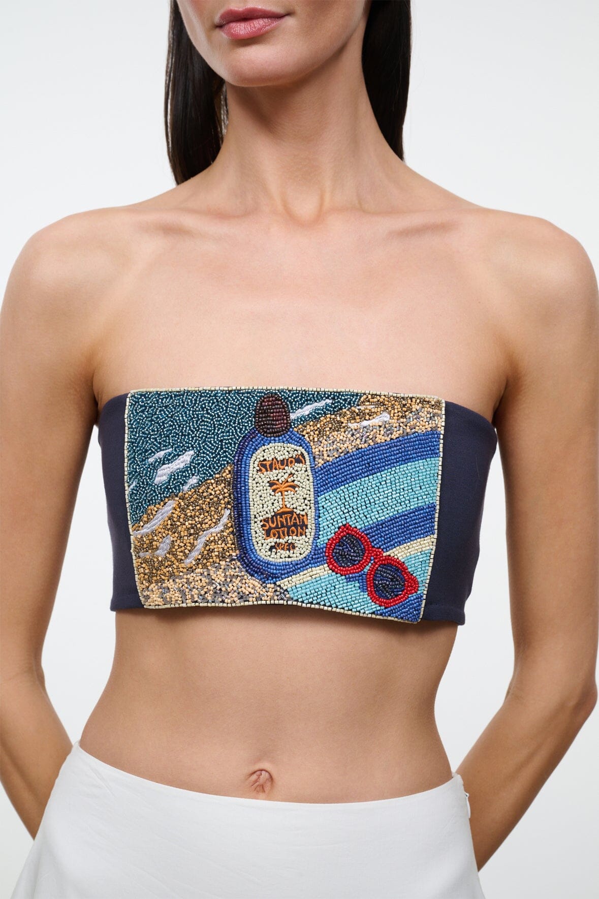 Strapless tube top featuring colorful central graphic print on navy