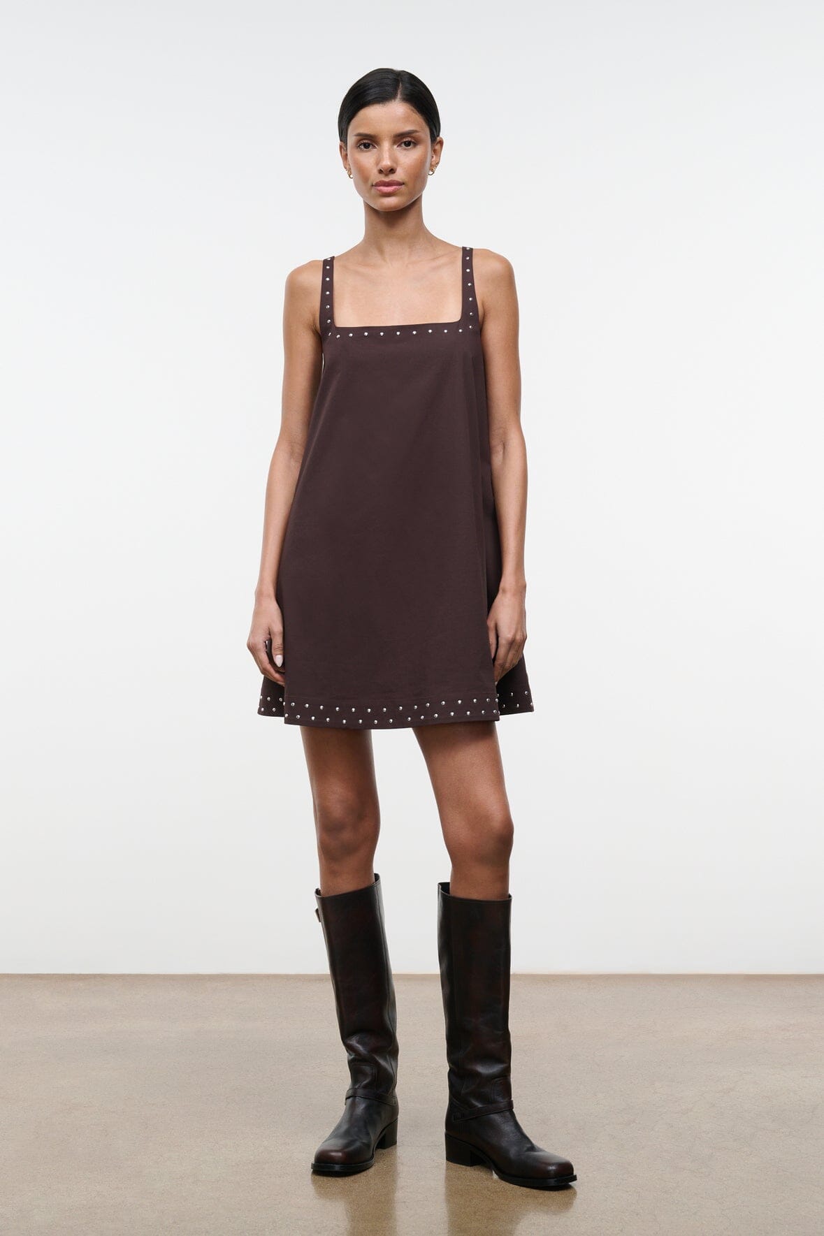 Dark brown sleeveless shift dress with square neckline and small stud embellishments along hem