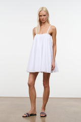 White mini dress with spaghetti straps and lace-trimmed gathered bodice.