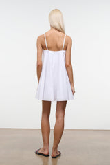 White mini dress, back view, with spaghetti straps and gathered waist.