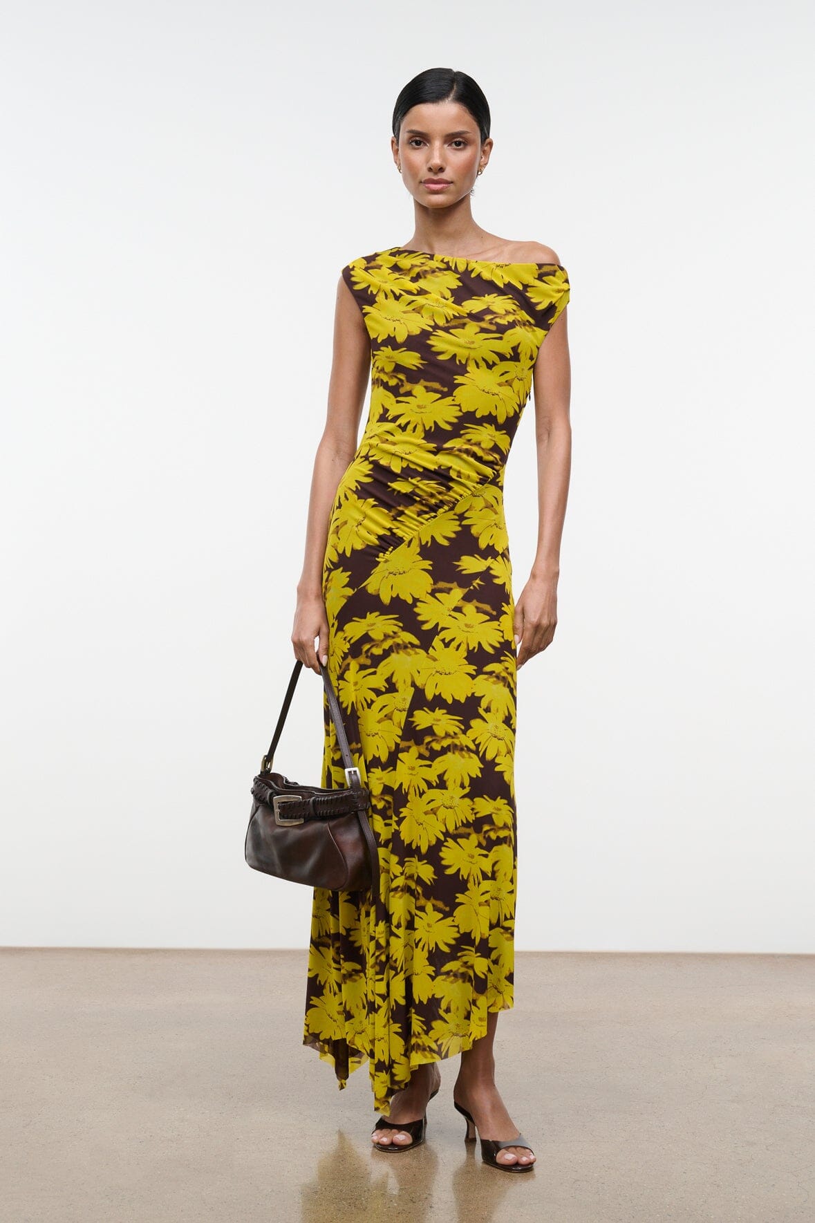 Off-shoulder printed maxi dress with yellow flower pattern on dark base