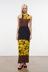 PRIMO sleeveless dress in black, brown, and yellow daisy print with red-trim seams