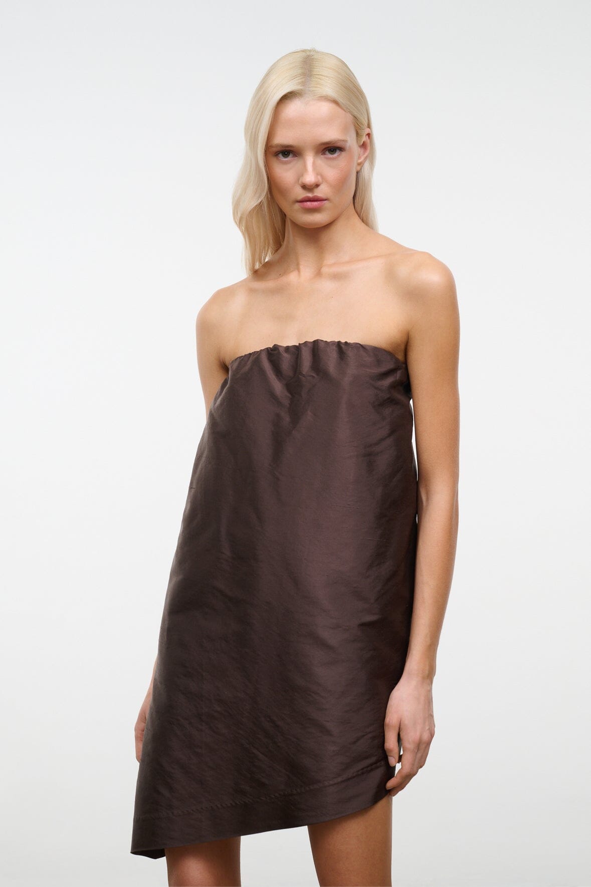 Dark brown strapless bandeau top with gathered bust and straight-to-asymmetrical hem