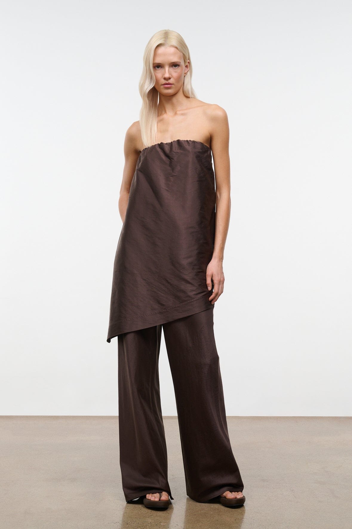 Dark brown strapless convertible top with gathered bust and uneven split hem