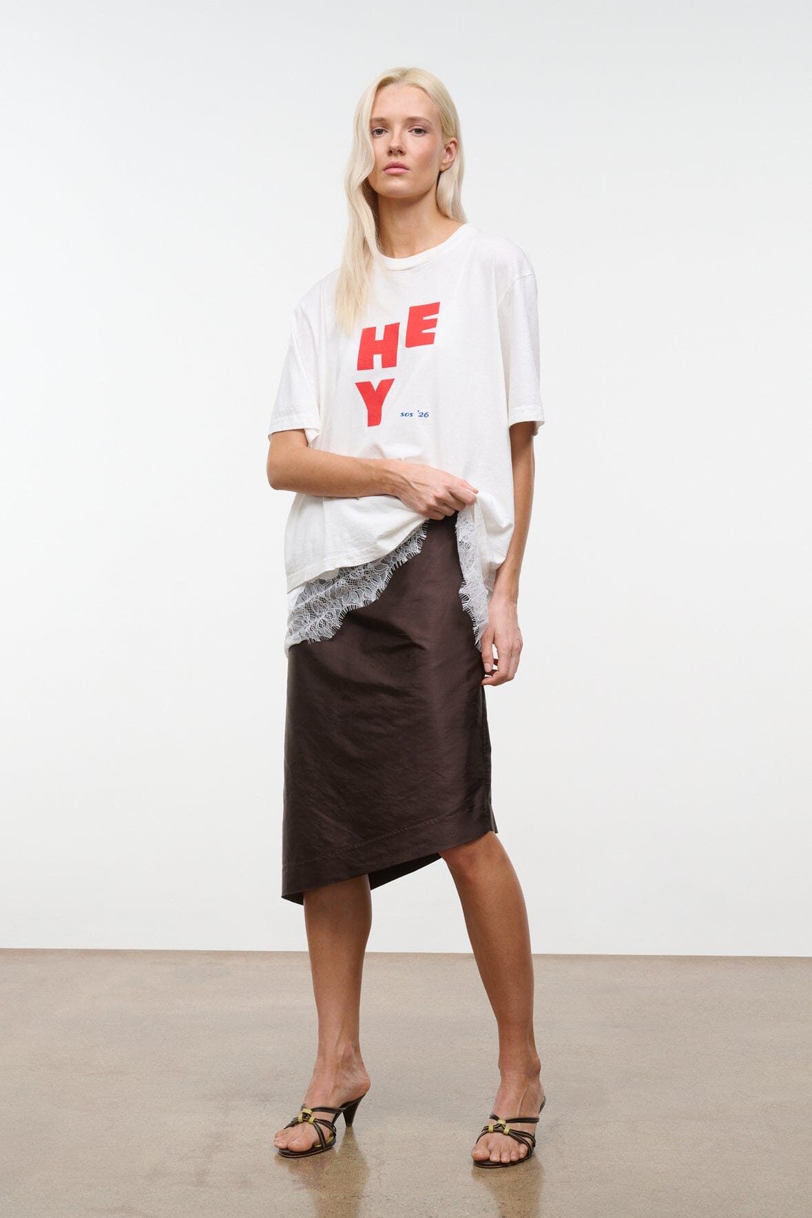 Dark brown convertible skirt-style top with gathered waistband and asymmetrical hem