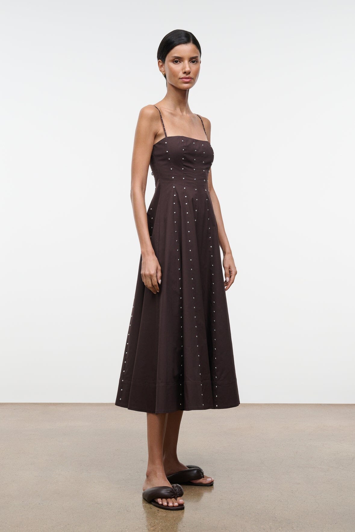Wylie midi dress with dark stud embellishments, fitted bodice and flared skirt