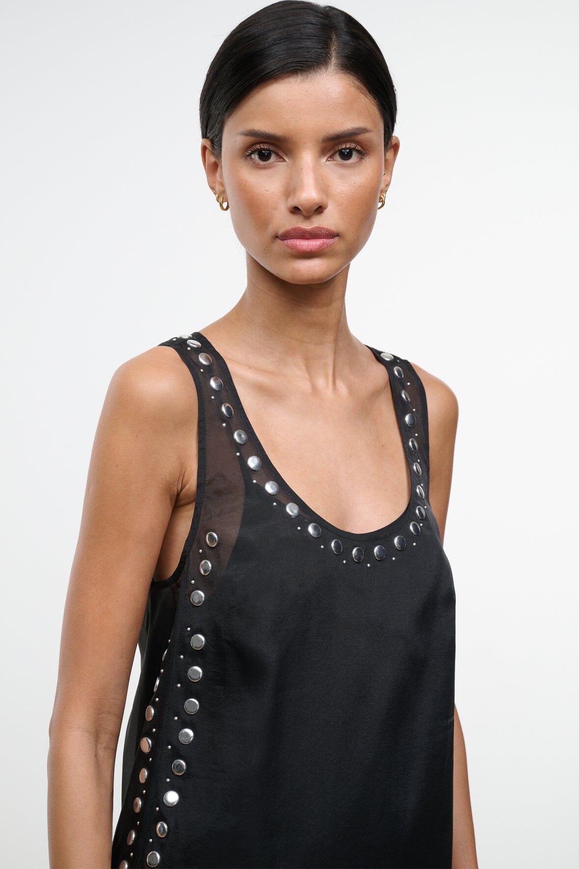 Black sleeveless dress with U-neck and vertical rows of silver-tone studs