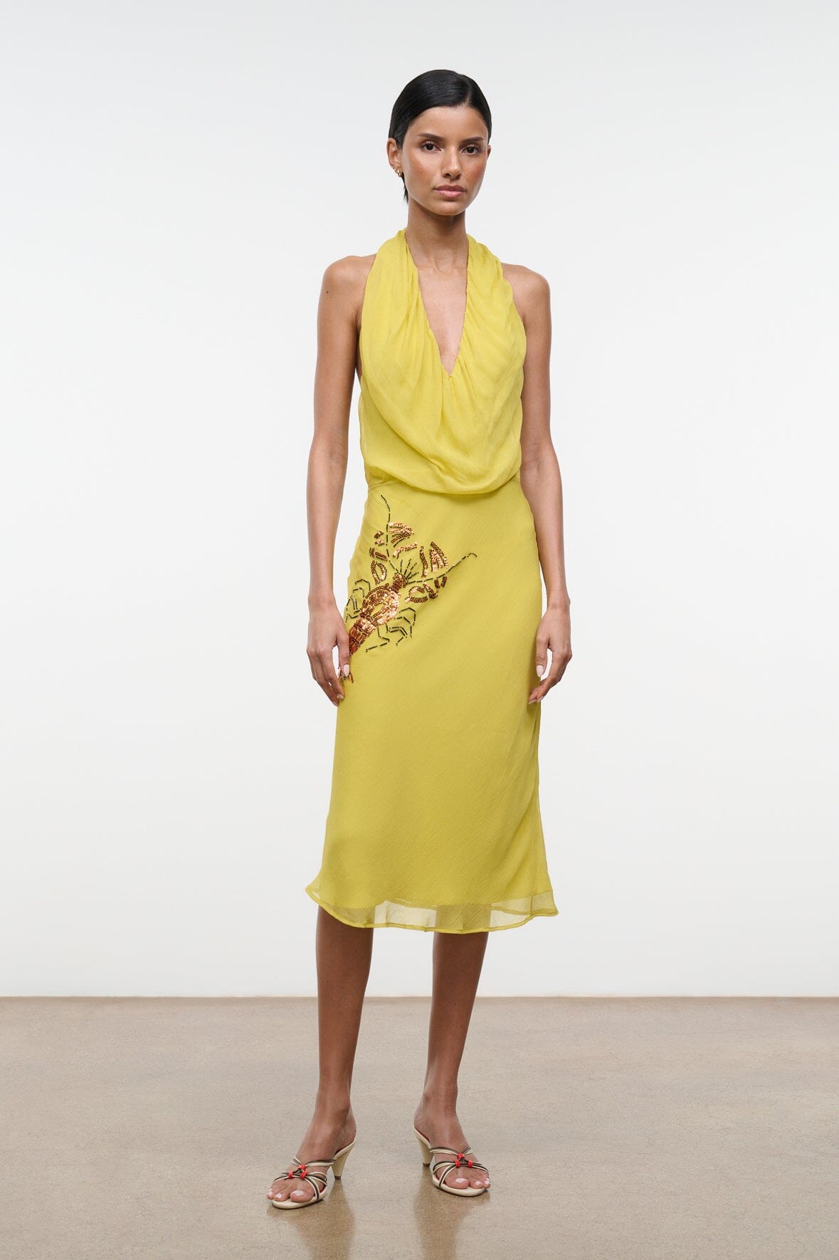 Citron yellow halter dress with draped cowl neckline and embroidered insect motif