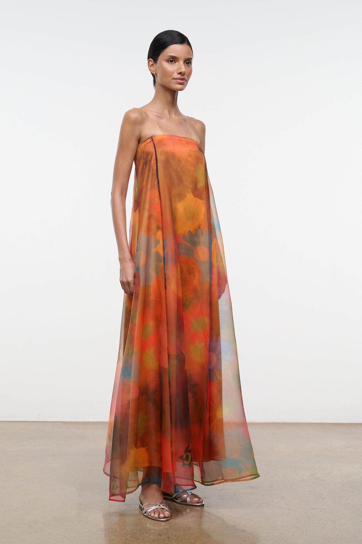 Strapless maxi dress with orange and teal abstract floral print, full-length