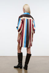 Back view shirt dress with vertical brown, cream, red & blue stripes and collared neck