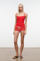 Tomato ribbed tank top with thin straps and scalloped trim, worn with drawstring shorts