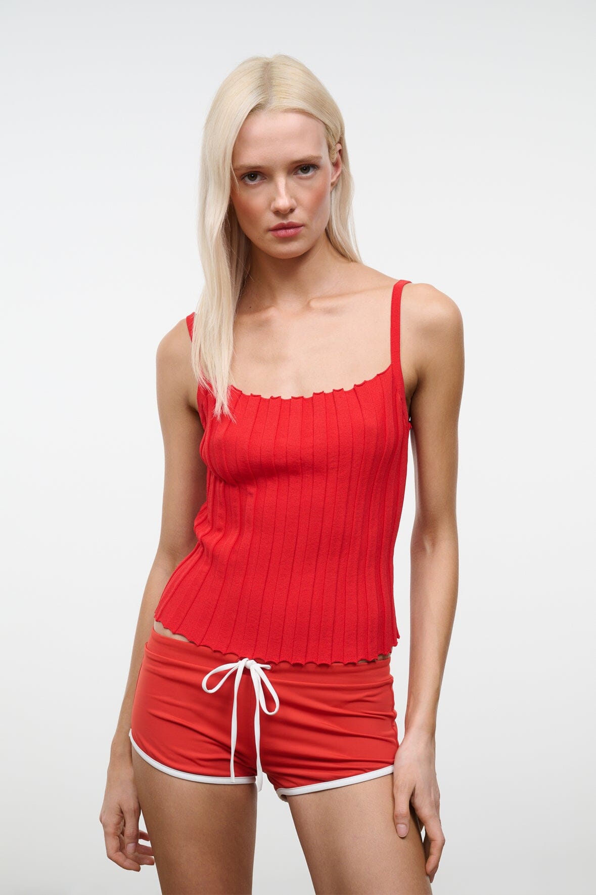 Tomato ribbed tank top with scalloped trim and ruched texture, close-up front