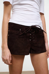 Dark brown suede shorts with lace-up drawstring, eyelets, and button front pockets