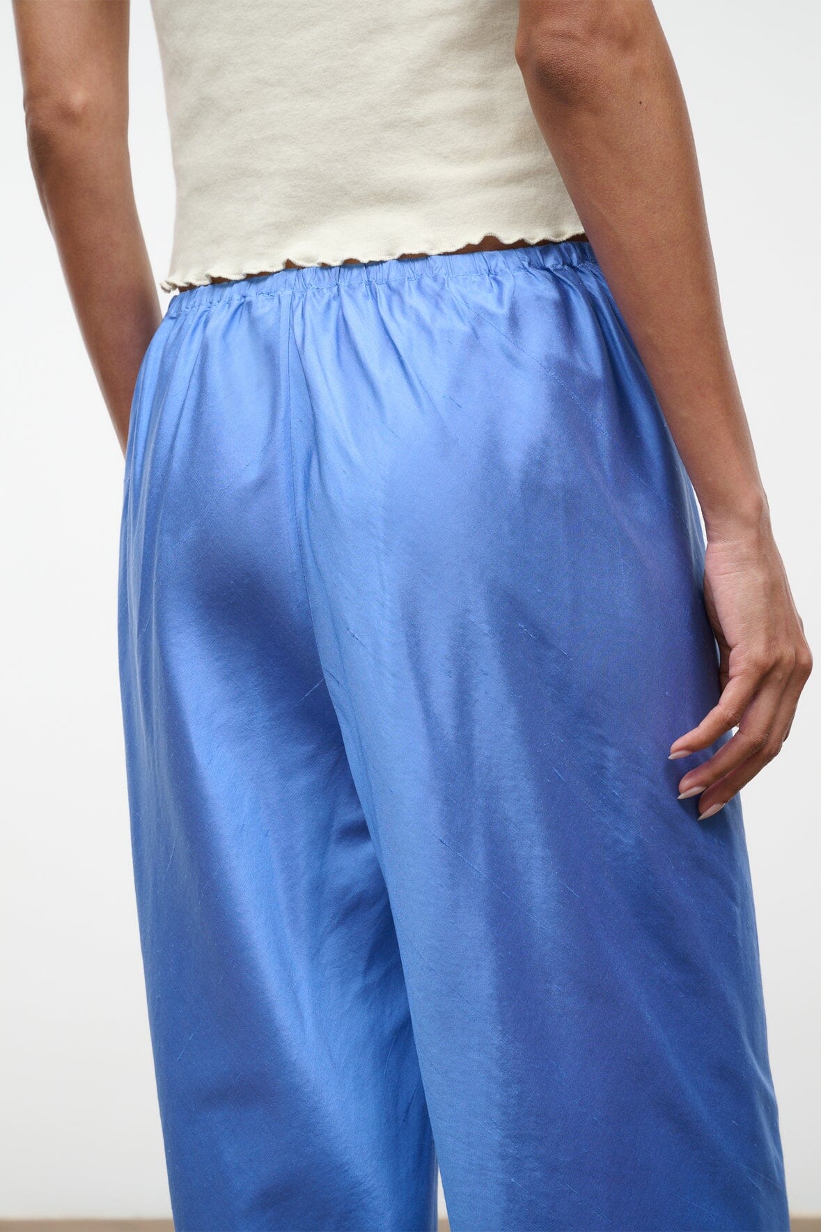 Light blue silk dupioni wide-leg pants with gathered waist and flowing fabric