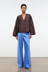 Light blue silk dupioni wide-leg pants with smooth drape and gathered waist