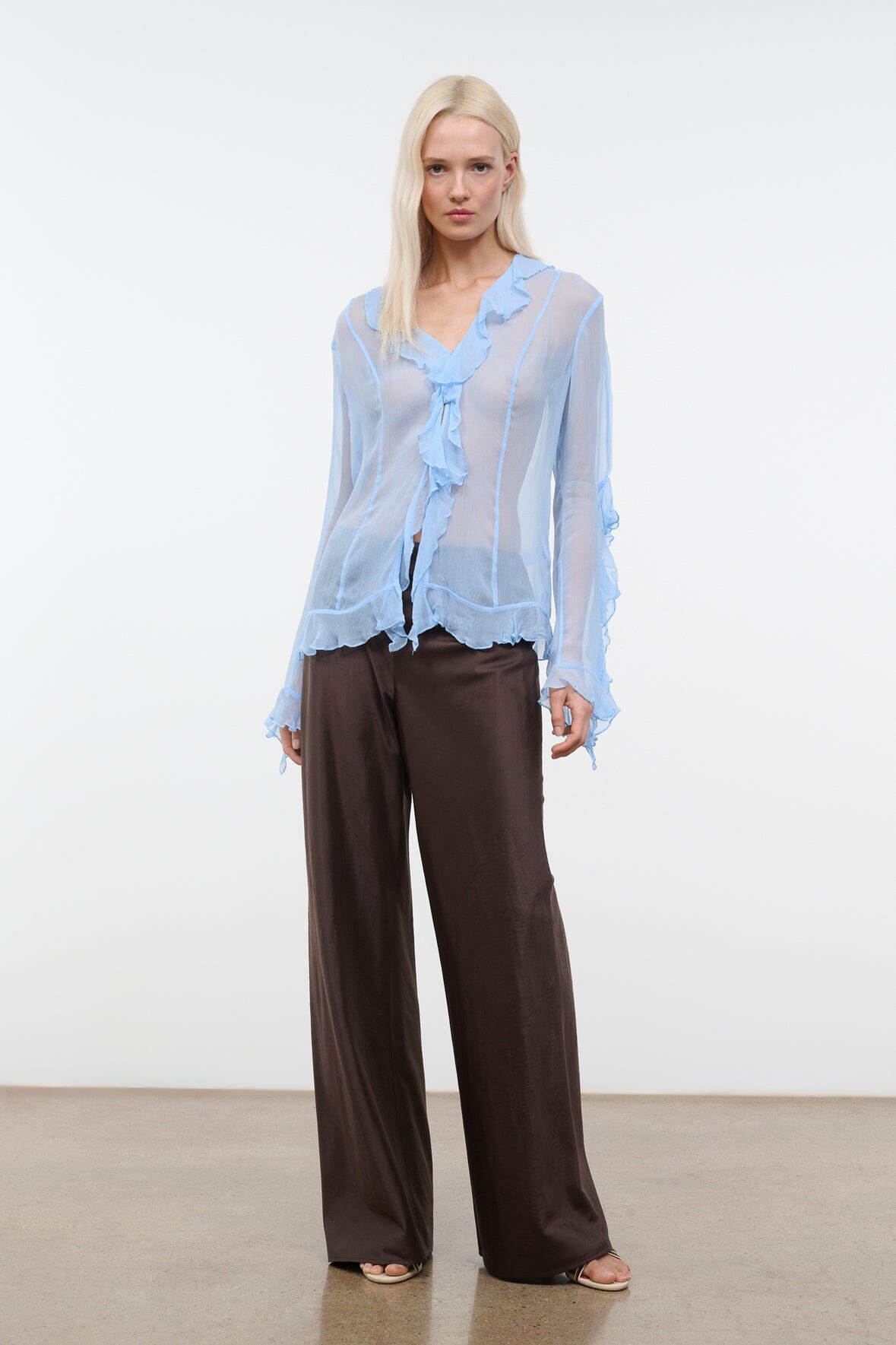 Dark brown wide-leg pants with relaxed drape and straight, flared hems
