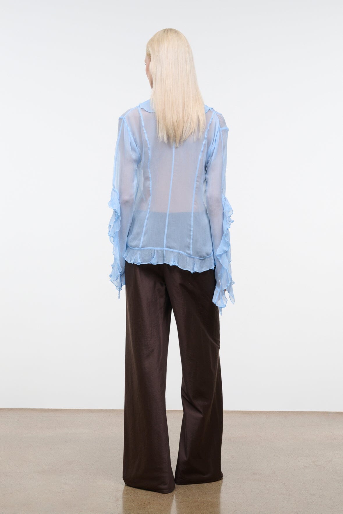 Back view of dark brown wide-leg silk dupioni pants with relaxed straight legs