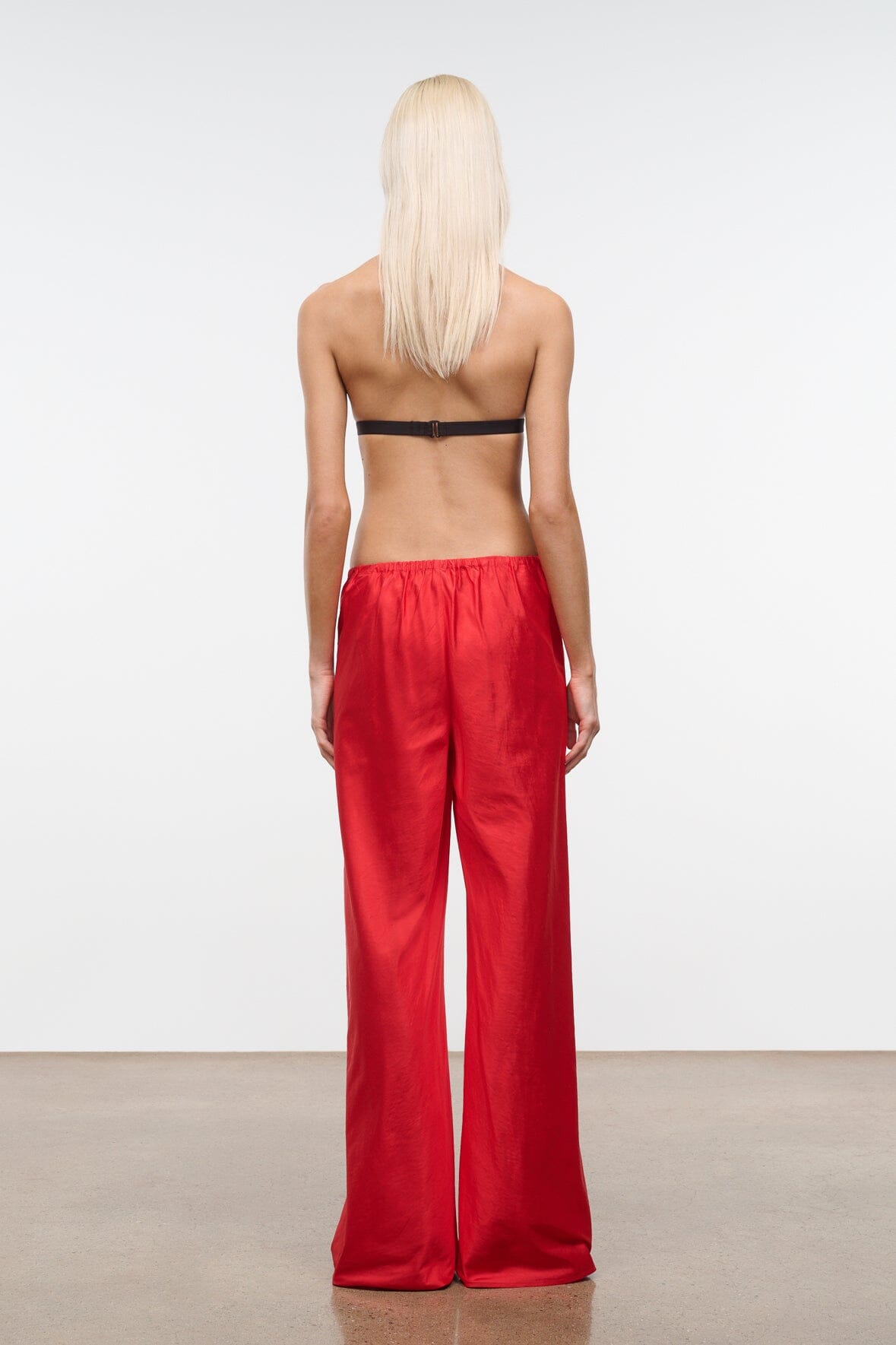 Back view of red silk dupioni wide-leg pants with elastic waist