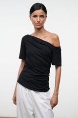 Black Carine top with draped diagonal off-shoulder neckline and short sleeves, front