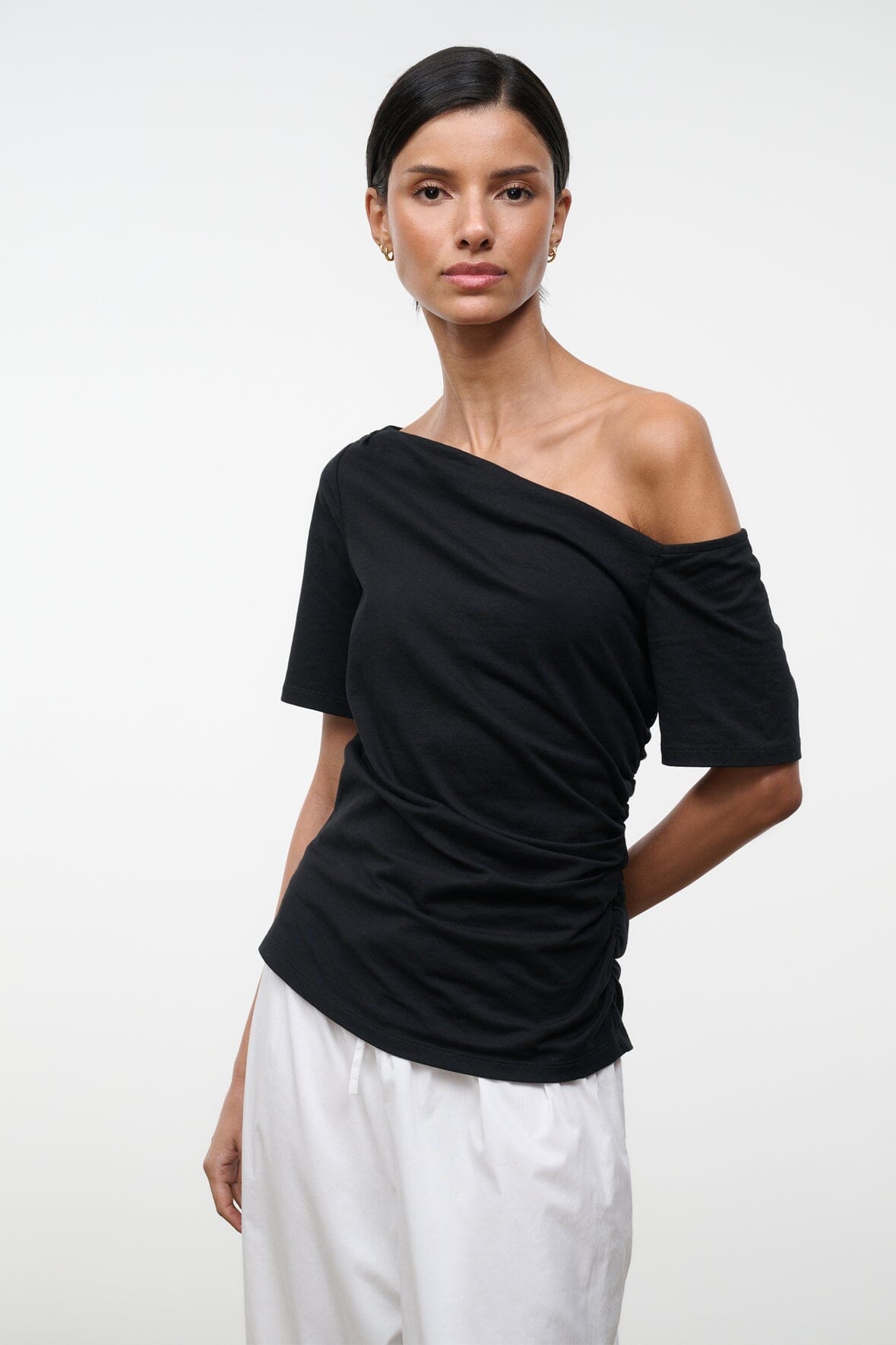 Black Carine top with asymmetrical off-shoulder neckline and short sleeves, close front