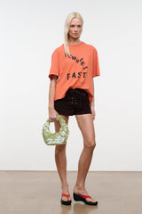 Orange relaxed crew-neck T-shirt with 'NOWHERE FAST' front graphic print