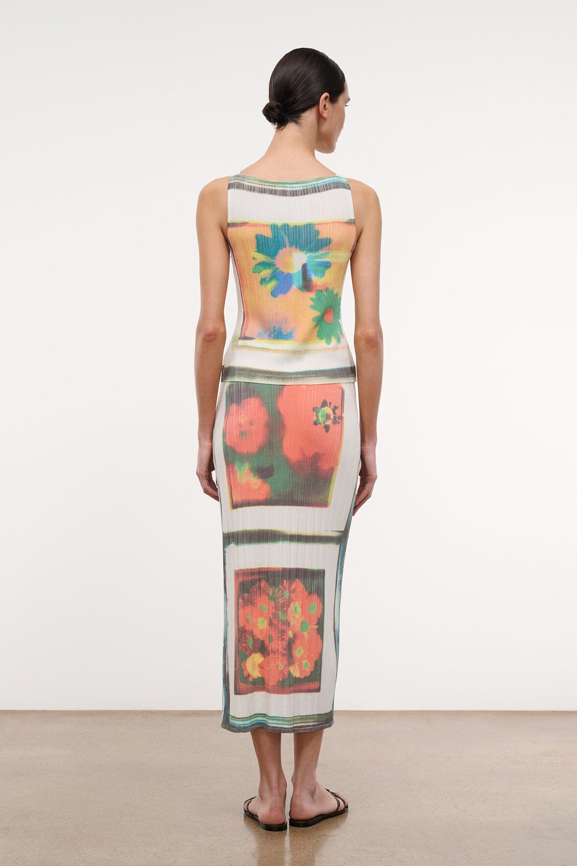 Back view of printed midi skirt with multicolor floral scarf-style panel and teal trim