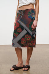 LUCIA skirt close-up: tie waist and multicolor diagonal panels with beaded flower detailing