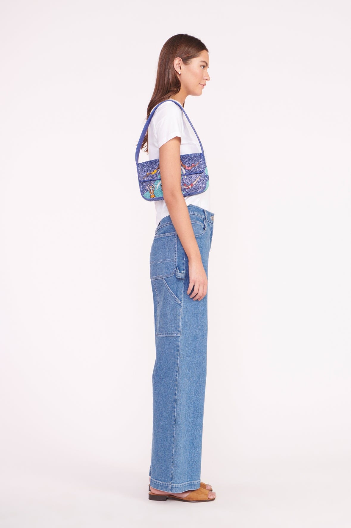 Beaded mini bag on model, blue swimmers print with top handle and front flap