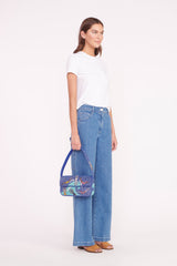 Beaded mini bag worn crossbody-style, blue swimmers print on model with jeans