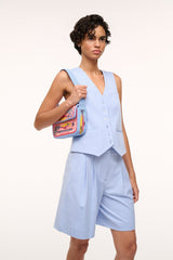 Light blue beaded mini bag carried across the chest with colorful front patch