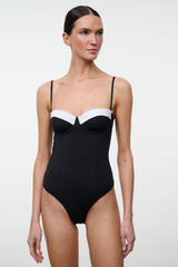 Black one-piece swimsuit with white bust panel and thin straps, front view