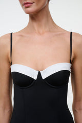 Black one-piece swimsuit with white sweetheart neckline and center V seam detail