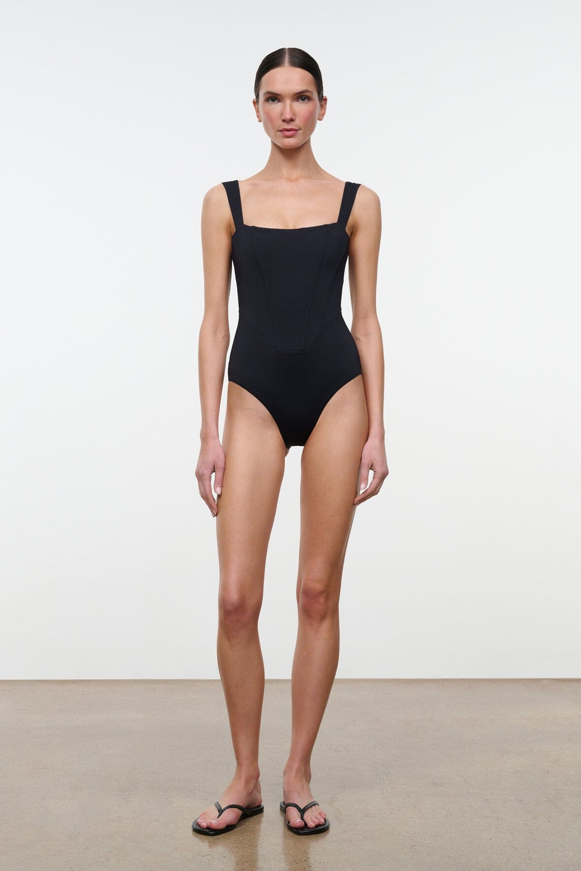 Black one-piece swimsuit with square neckline and high-cut leg front view