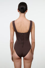 Dark one-piece swimsuit with scoop back, thin straps, and center back closure