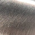 Silver metal ashtray surface close-up with brushed texture