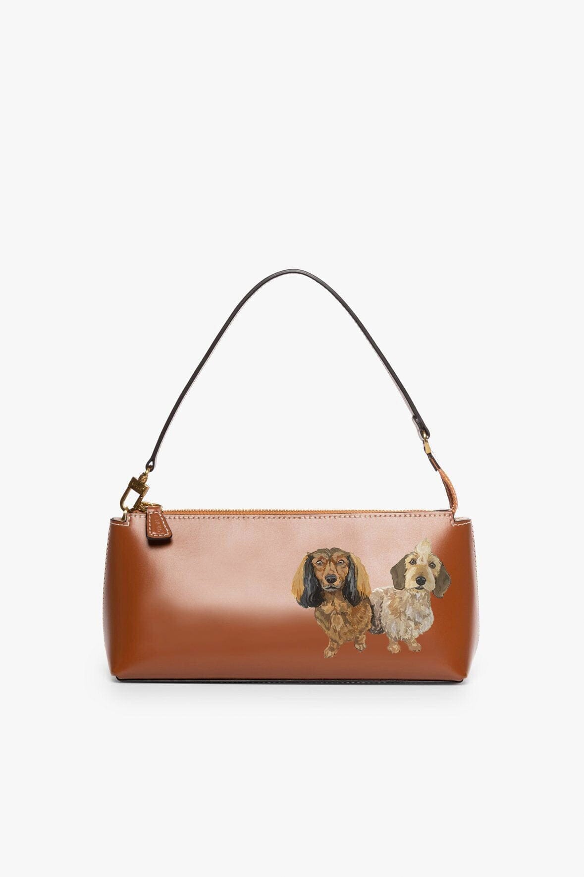 Tan handbag with two dogs illustration on front, top handles and gold-tone trim