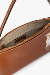 Tan zipper-top bag with inner pocket and leather patch, dog graphic