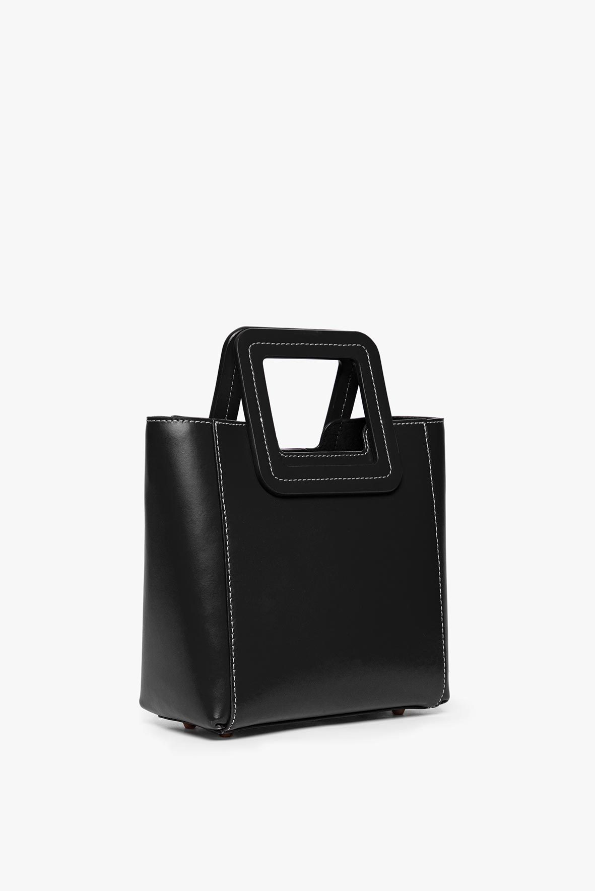 Black structured leather mini bag with top handle and side profile