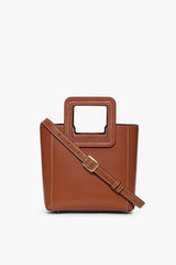 Saddle brown mini leather bag with crossbody strap and square cutout handle