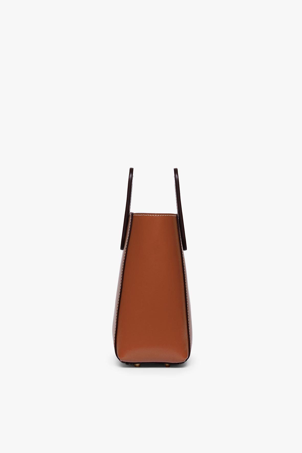 Saddle brown mini leather bag bottom view with narrow top handles
