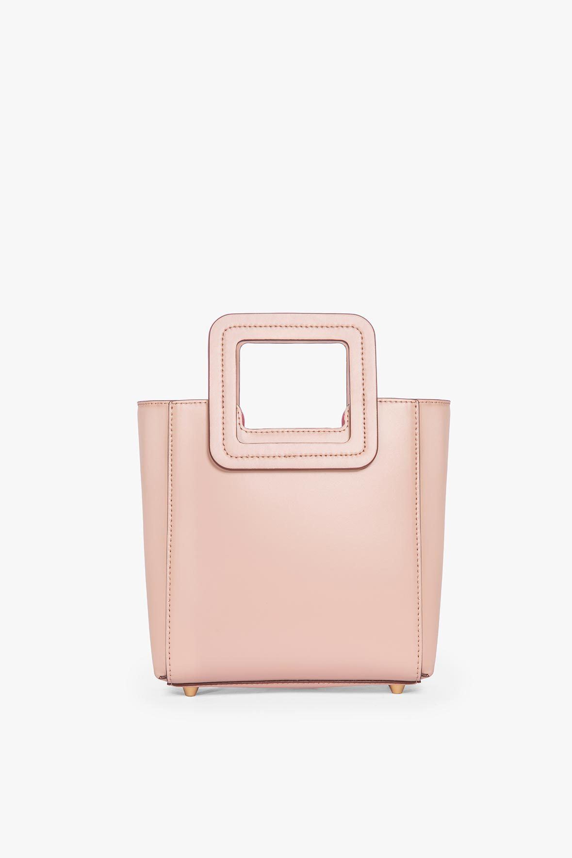 Blush leather mini tote bag with top handle and square cutout front panel