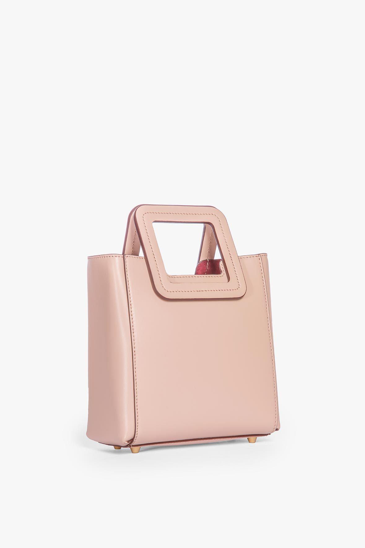 Blush leather mini tote bag with structured top handles and stitched trim