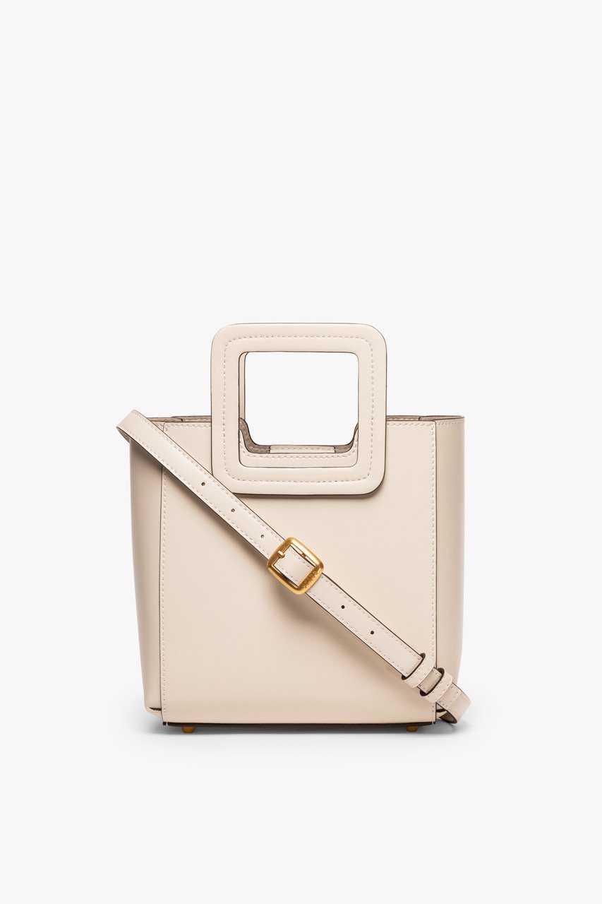 Mini cream leather bag with long crossbody strap and gold buckle